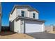 Charming home featuring a two-car garage, complemented by desert landscaping, and a sunny, blue sky at 1588 N Pueblo Dr, Apache Junction, AZ 85120