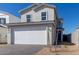 Charming home featuring a two-car garage, complemented by desert landscaping, and a sunny, blue sky at 1588 N Pueblo Dr, Apache Junction, AZ 85120