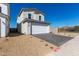 Beautiful two-story home showcasing desert landscaping, a brick driveway, and a spacious two-car garage at 1588 N Pueblo Dr, Apache Junction, AZ 85120