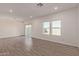 Bright living room featuring wood-look tile flooring, recessed lighting and large sliding glass doors to the backyard at 1588 N Pueblo Dr, Apache Junction, AZ 85120