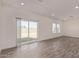 Bright living room featuring wood-look tile flooring, recessed lighting and large sliding glass doors to the backyard at 1588 N Pueblo Dr, Apache Junction, AZ 85120