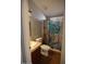 Bathroom featuring a sink and toilet, with a floral-themed shower curtain at 17016 N 66Th Ter, Glendale, AZ 85308