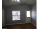 Neutral bedroom featuring laminate floors, a window and a door to the exterior at 17016 N 66Th Ter, Glendale, AZ 85308