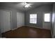 Neutral bedroom featuring high ceilings, laminate floors, and closet doors at 17016 N 66Th Ter, Glendale, AZ 85308