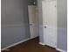 Standard bedroom with light grey walls, wood floor and two white paneled doors at 17016 N 66Th Ter, Glendale, AZ 85308