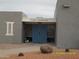 View of the Casa Campana clubhouse with blue doors and a well-maintained landscape at 17016 N 66Th Ter, Glendale, AZ 85308