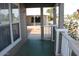 View of the home's charming front porch with painted wood and view of neighborhood at 17016 N 66Th Ter, Glendale, AZ 85308