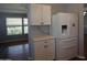 Bright kitchen featuring a modern refrigerator and white cabinets at 17016 N 66Th Ter, Glendale, AZ 85308