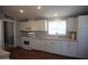 Modern kitchen featuring white cabinets, stainless steel appliances, and ample counter space for meal preparation at 17016 N 66Th Ter, Glendale, AZ 85308