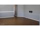 Bright living room with contemporary flooring, neutral walls, and open access to other areas of the home at 17016 N 66Th Ter, Glendale, AZ 85308