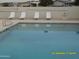 A community swimming pool with lounge chairs provides a spot to unwind poolside at 17016 N 66Th Ter, Glendale, AZ 85308