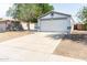 Front exterior showcasing a two-car garage and easy-care gravel landscaping at 1793 S Valley Dr, Apache Junction, AZ 85120