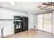 Efficient kitchen with white cabinetry, black appliances, and a sliding glass door at 1793 S Valley Dr, Apache Junction, AZ 85120