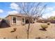 Gravel backyard featuring a patio, block fence, and desert landscaping at 18382 N Arbor Dr, Maricopa, AZ 85138