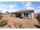 Backyard featuring desert landscaping, BBQ grill, patio and privacy wall at 18382 N Arbor Dr, Maricopa, AZ 85138