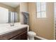 Neutral colored bathroom with vanity, a shower/tub and a window for natural light at 18382 N Arbor Dr, Maricopa, AZ 85138