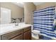 Bathroom featuring vanity and a bathtub with a blue and white striped shower curtain at 18382 N Arbor Dr, Maricopa, AZ 85138