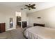 Neutral bedroom with a ceiling fan, carpet flooring, dresser and access to bath at 18382 N Arbor Dr, Maricopa, AZ 85138