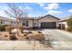 Charming single-story home with desert landscaping, stone accents, and a two-car garage at 18382 N Arbor Dr, Maricopa, AZ 85138