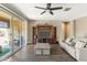 Inviting living room with a sliding glass door and entertainment center at 18382 N Arbor Dr, Maricopa, AZ 85138