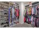 Open walk-in closet with multiple sections for shoes and clothing storage at 18382 N Arbor Dr, Maricopa, AZ 85138