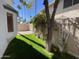 Charming backyard with a lush lawn, framed by trees and a partial view of the house at 18608 N 4Th Ave, Phoenix, AZ 85027