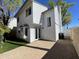 A spacious backyard with a brick-paved patio, white stucco walls, and lush greenery creates a private outdoor retreat at 18608 N 4Th Ave, Phoenix, AZ 85027