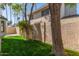 Exterior shot of a backyard featuring lush grass, mature trees, and a beige privacy fence at 18608 N 4Th Ave, Phoenix, AZ 85027