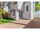 Backyard view of a two-story home featuring a brick-paved patio and manicured lawn at 18608 N 4Th Ave, Phoenix, AZ 85027