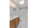 A bathroom featuring a tub with sliding glass doors, patterned tile floors, and a skylight at 18608 N 4Th Ave, Phoenix, AZ 85027