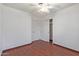 A well-lit bedroom with laminate wood flooring, a closet with sliding doors, and neutral wall color at 18608 N 4Th Ave, Phoenix, AZ 85027