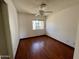 Bright bedroom with a ceiling fan and window providing natural light, complemented by dark hardwood floors at 18608 N 4Th Ave, Phoenix, AZ 85027