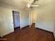 Bedroom with a ceiling fan, closet, and hardwood floors, creating a cozy atmosphere at 18608 N 4Th Ave, Phoenix, AZ 85027