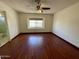 Bedroom with wood floors, ceiling fan, and a window with a view at 18608 N 4Th Ave, Phoenix, AZ 85027