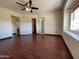 Large bedroom with ceiling fan, wood flooring, and multiple closets and access to ensuite bathroom at 18608 N 4Th Ave, Phoenix, AZ 85027