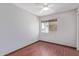 This bedroom features hardwood floors, a ceiling fan, and a window with bright, natural light at 18608 N 4Th Ave, Phoenix, AZ 85027