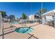 Community pool with a spa, tables, and chairs, and a bright blue sky at 18608 N 4Th Ave, Phoenix, AZ 85027