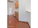 Hallway with hardwood floors, built-in cabinets, and an open doorway view to the bathroom at 18608 N 4Th Ave, Phoenix, AZ 85027