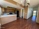 Open floor plan of kitchen with wooden cabinets, black appliances, breakfast bar and a chandelier at 18608 N 4Th Ave, Phoenix, AZ 85027