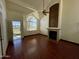 Bright and airy living room with a cozy fireplace, wood floors, and a large window at 18608 N 4Th Ave, Phoenix, AZ 85027