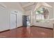 Open living room with a security door, featuring a fireplace, wood floors, vaulted ceiling, and lots of natural light at 18608 N 4Th Ave, Phoenix, AZ 85027