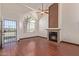 Spacious living room featuring a fireplace, wood floors, vaulted ceiling, and lots of natural light at 18608 N 4Th Ave, Phoenix, AZ 85027