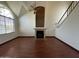 Bright and airy living room with a cozy fireplace, wood floors, and a large window at 18608 N 4Th Ave, Phoenix, AZ 85027