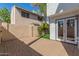 Enclosed brick patio area with door leading into the home and greenery around the perimeter at 18608 N 4Th Ave, Phoenix, AZ 85027