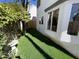 A verdant side yard features a manicured lawn, mature trees, and a classic bird bath at 18608 N 4Th Ave, Phoenix, AZ 85027