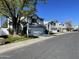 A street view captures a row of well-maintained homes, each featuring its own garage and landscaped front yard at 18608 N 4Th Ave, Phoenix, AZ 85027