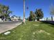 A street view captures a row of well-maintained homes, each featuring its own garage and landscaped front yard at 18608 N 4Th Ave, Phoenix, AZ 85027