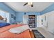 Blue bedroom with a wooden bed, reading nook, and natural light at 2013 E Dust Devil Dr, San Tan Valley, AZ 85143