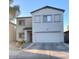 Two-story home featuring a two-car garage and low-maintenance landscaping at 2013 E Dust Devil Dr, San Tan Valley, AZ 85143