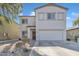 Two-story home with neutral stucco, a two-car garage, and simple desert landscaping at 2013 E Dust Devil Dr, San Tan Valley, AZ 85143